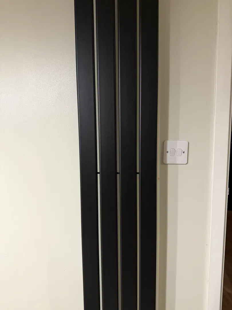 Vertical radiator installation by plumber in Cardiff
