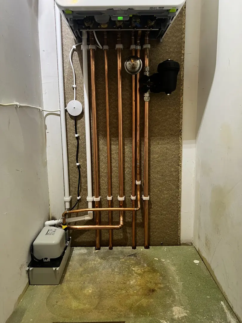 Tidy boiler cupboard install with copper pipework and condensate pump in Bridgend