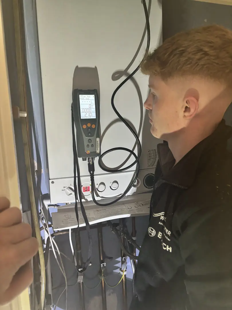 Gas Safe registered heating engineer performing boiler gas analysis testing in Bridgend