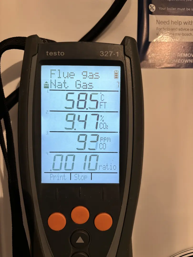Gas Safe registered engineer using Testo flue gas analyser for boiler service in Bridgend