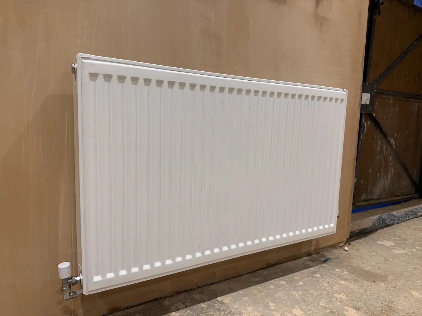 White panel radiator installation in a new build property in Bridgend