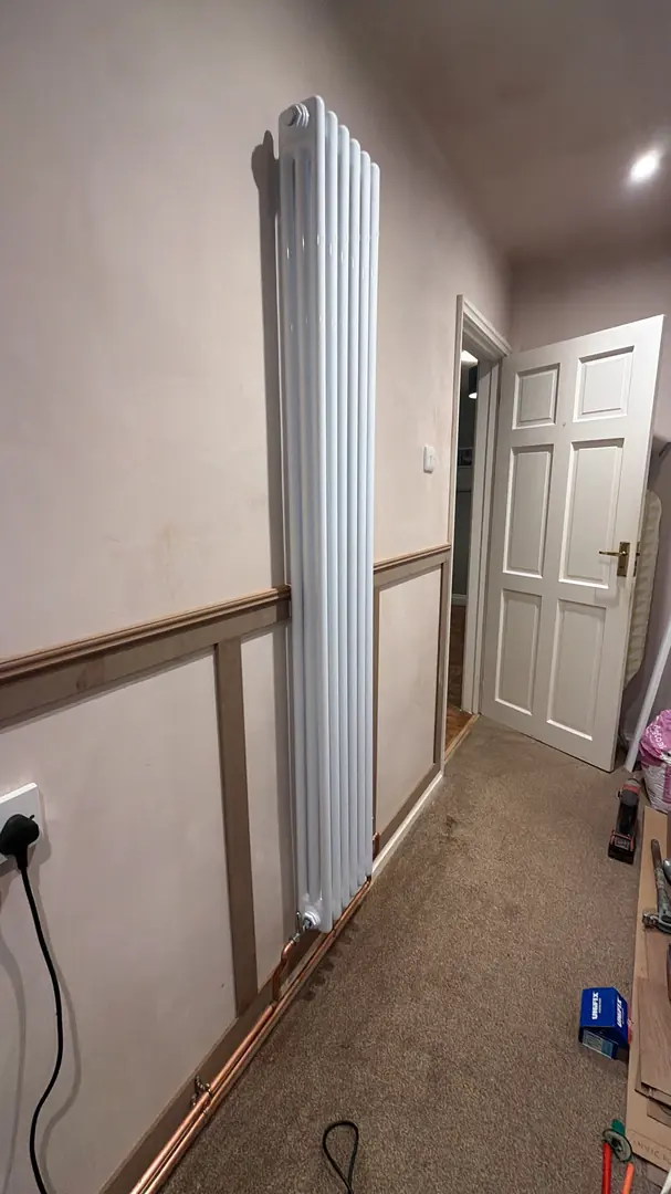Vertical radiator installation in a hallway in Cardiff