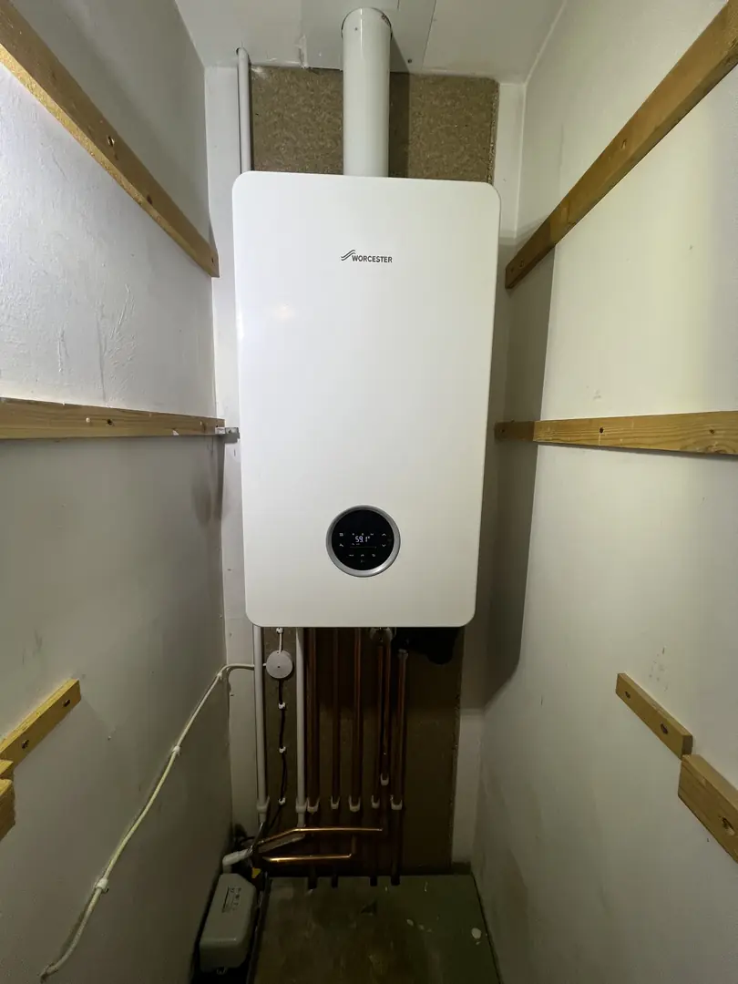Worcester Bosch boiler replacement in cupboard by heating engineer Bridgend