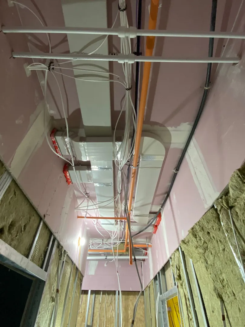 MVHR ducting first fix in ceiling void with fire dampers on a Bridgend new build
