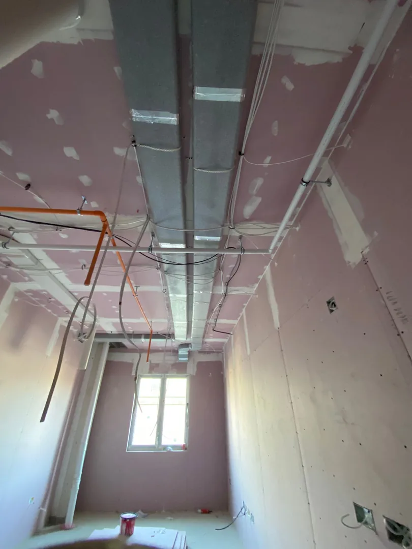 Main MVHR duct run at first fix stage in a Bridgend ceiling void