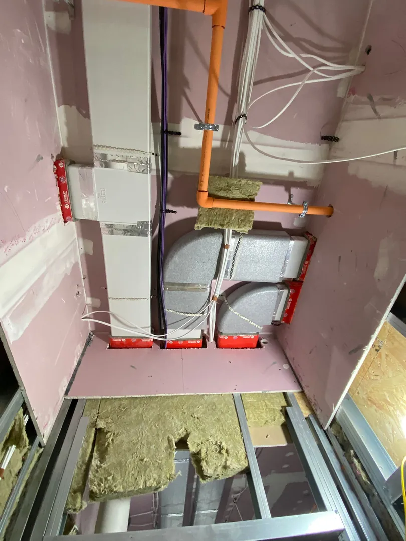 MVHR unit installed in a cupboard with insulated ductwork in Bridgend