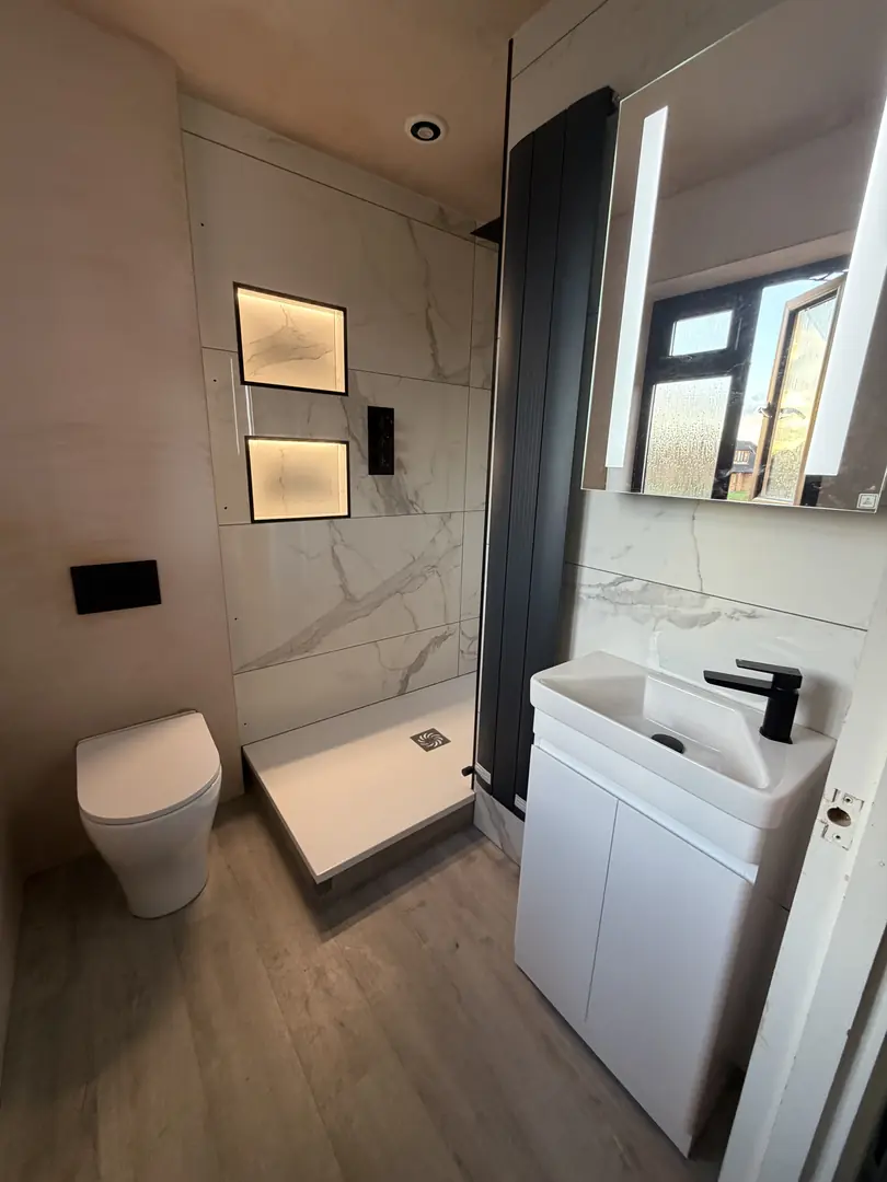 Modern bathroom installation with wall-hung toilet and vanity unit in Port Talbot