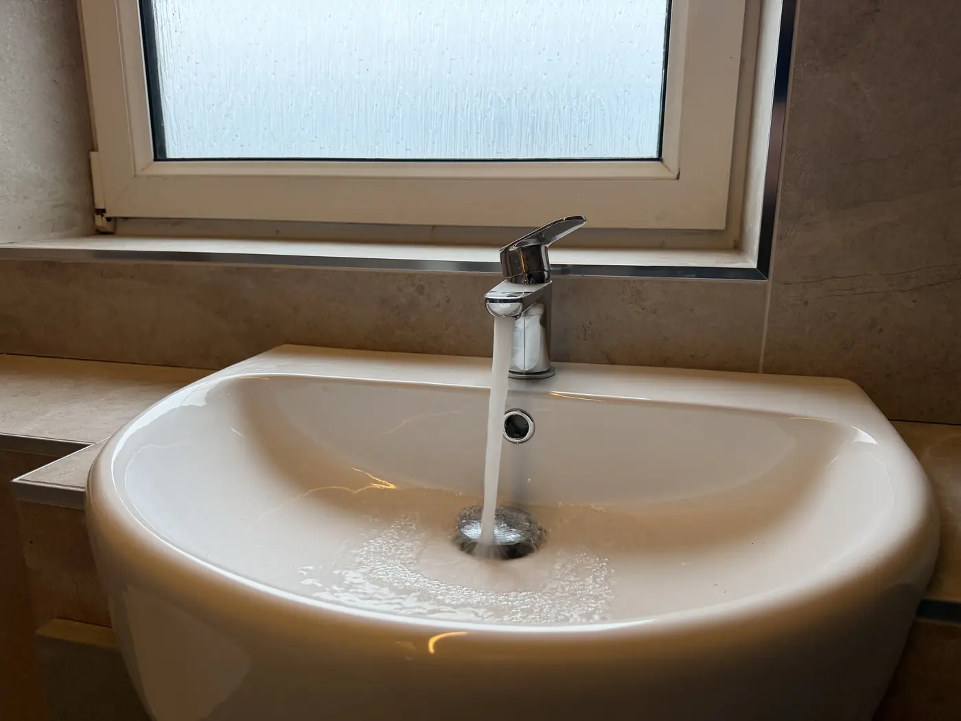 Chrome mixer tap installation close-up by plumber in Bridgend