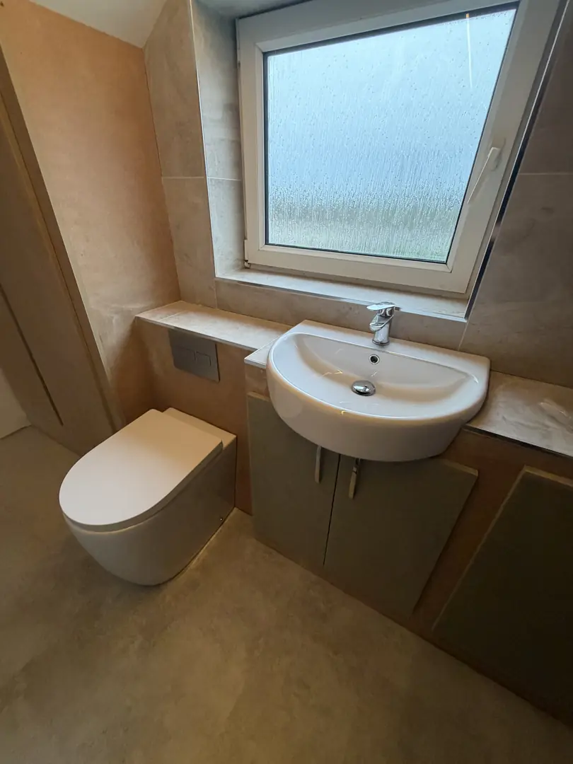 En-suite bathroom installation with wall-hung toilet and basin in Bridgend